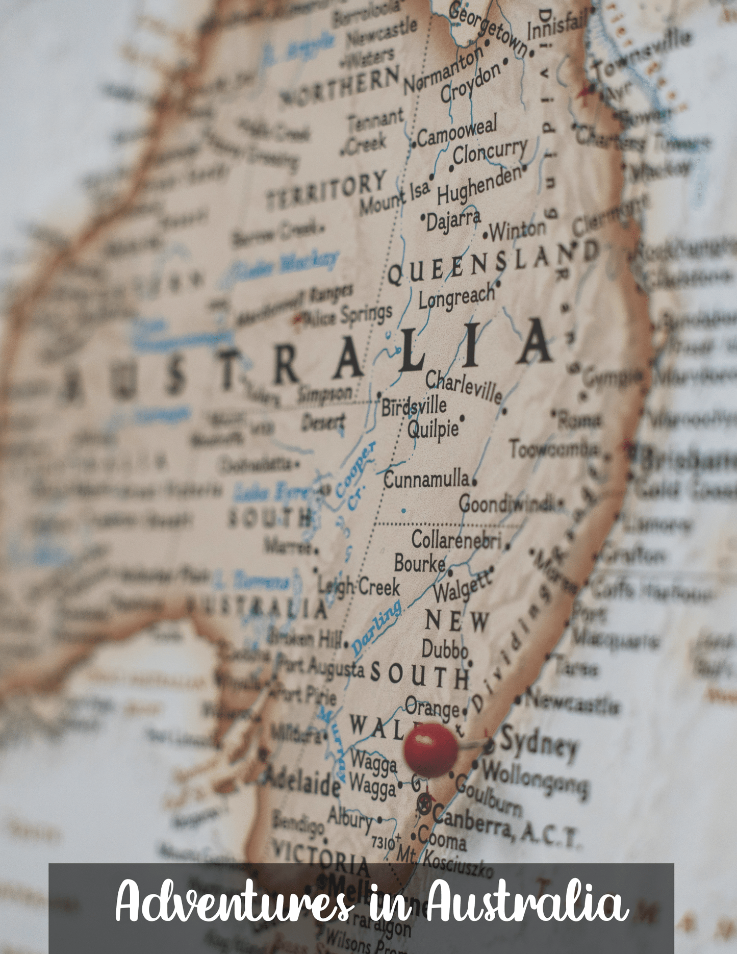 A map of Australia with a red pin marking a location in New South Wales. The phrase "Adventures in Australia Activity Pack by Wondermom Shop" is overlaid at the bottom of the image.