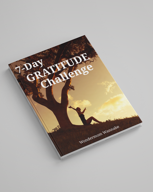 Cover of a book titled "7-Day Gratitude Journal Ebook" featuring a silhouetted person sitting under a tree at sunset. This inspiring digital product is brought to you by Wondermom Shop.