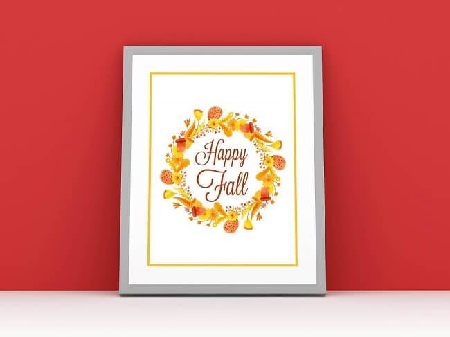 The VIP Vault "Happy Fall Printable Sign" features cursive text surrounded by an autumn wreath—ideal as a digital product or free printable for your seasonal fall decor, displayed beautifully against a red wall.