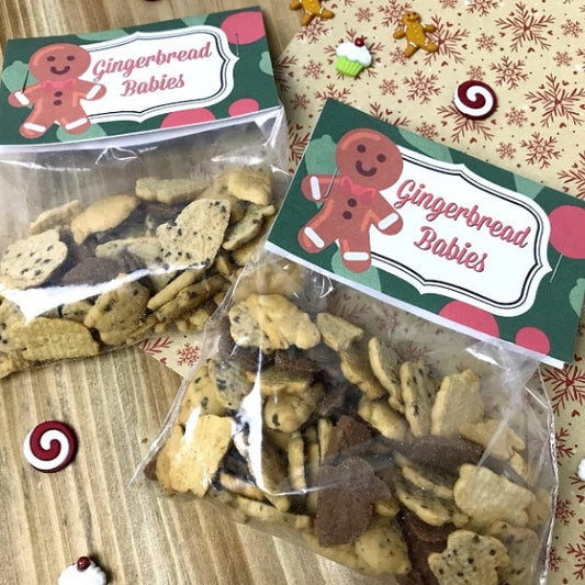 Two bags of VIP Vault Gingerbread Babies Treat Bags are displayed on a table, exuding Christmas cheer. These VIP Vault Gingerbread Babies Treat Bags make for a delightful DIY gift idea during the holiday season.