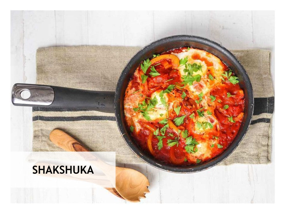 Enjoy a skillet of shakshuka with poached eggs in spiced tomato-pepper sauce, a featured dish from the Wondermom Wannabe 5-Ingredient Healthy Recipes Digital Cookbook—ideal for easy meal plans and quick, wholesome cooking.