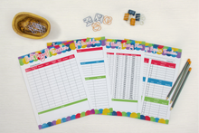 Load image into Gallery viewer, A set of colorful Wondermom Shop Budget Planners and pencils on a white table.

