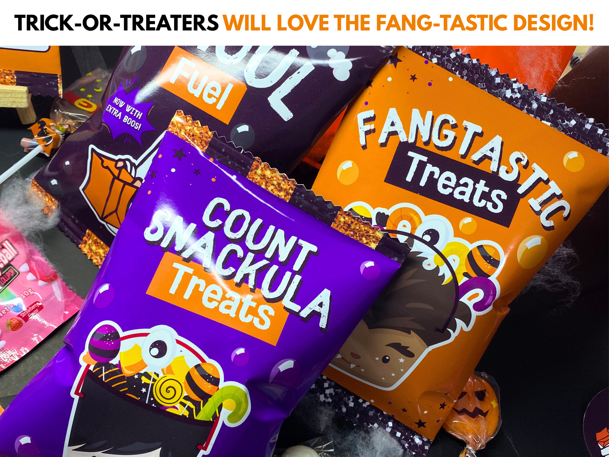 Printable Halloween Chip Bags from Wondermom Shop, featuring festive designs like "Ghoul Fuel," "Fangtastic Treats," and "Count Snackula Treats," are displayed on a table for extra spooky party fun.