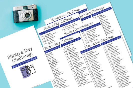 A photo features a camera and pages highlighting "Photo-a-Day Challenge: A Year of Creativity" by Wondermom Shop, with monthly prompts such as "Everyday Magic" and "New Beginnings," designed to boost photography skills through daily creative themes.