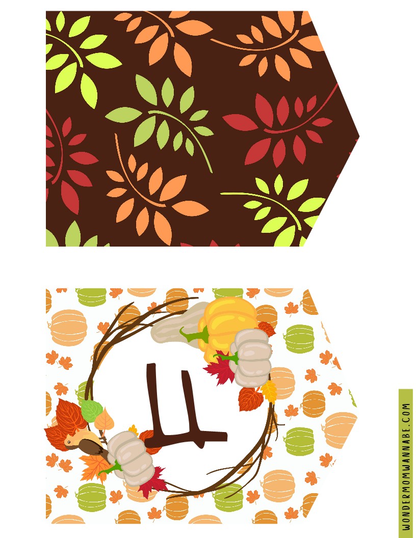 Two triangular paper decorations with autumn-themed designs: one featuring colorful leaves on a brown background, and the other showcasing pumpkins, leaves, and a twig wreath on a white background. Perfect additions to your Wondermom Shop's Fall Festival Party Kit, these printable elements effortlessly bring seasonal charm.