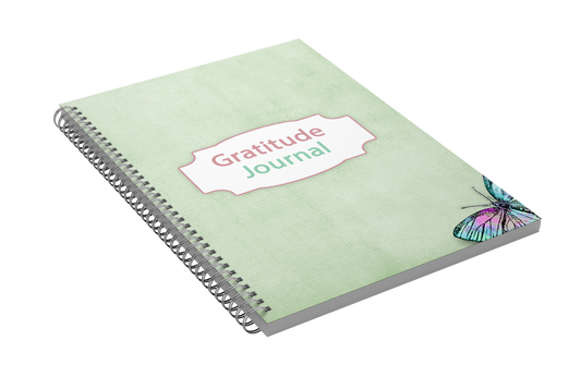 This Wondermom Shop Gratitude Journal features a light green spiral-bound cover adorned with a vibrant butterfly illustration in the bottom right corner. The center displays the title "30 Days of Gratitude Workbook," offering daily prompts designed to help cultivate a grateful mindset.