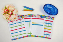 Load image into Gallery viewer, A set of Budget Planner notebooks and pens from Wondermom Shop on a table.
