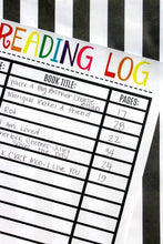 Load image into Gallery viewer, A VIP Vault Reading Log for Kids on top of a black and white striped tablecloth.
