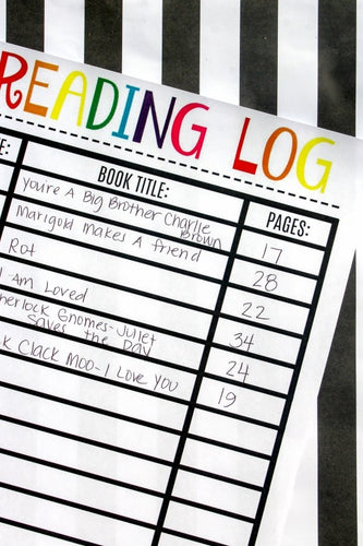 A VIP Vault Reading Log for Kids on top of a black and white striped tablecloth.