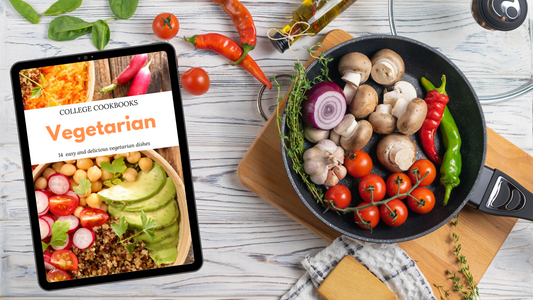 A tablet with a Vegetarian College Cookbook by Wondermom Wannabe on it next to a frying pan with vegetarian recipes for college students.